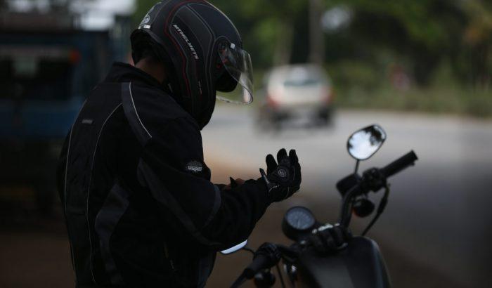 Man putting gloves before a motorbike ride